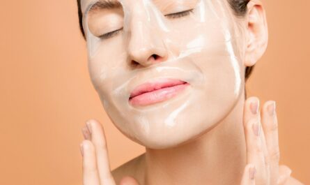 Woman enjoying a rejuvenating face mask treatment, promoting skin health and relaxation.